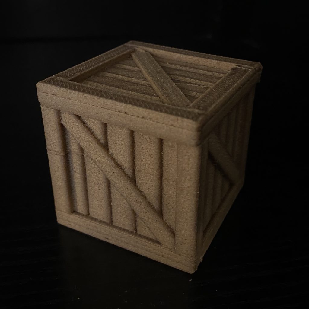 Print of a wood box using PLA that has wood fibers in it - so it looks pretty much like wood.  Lots of interesting material are available these days!
